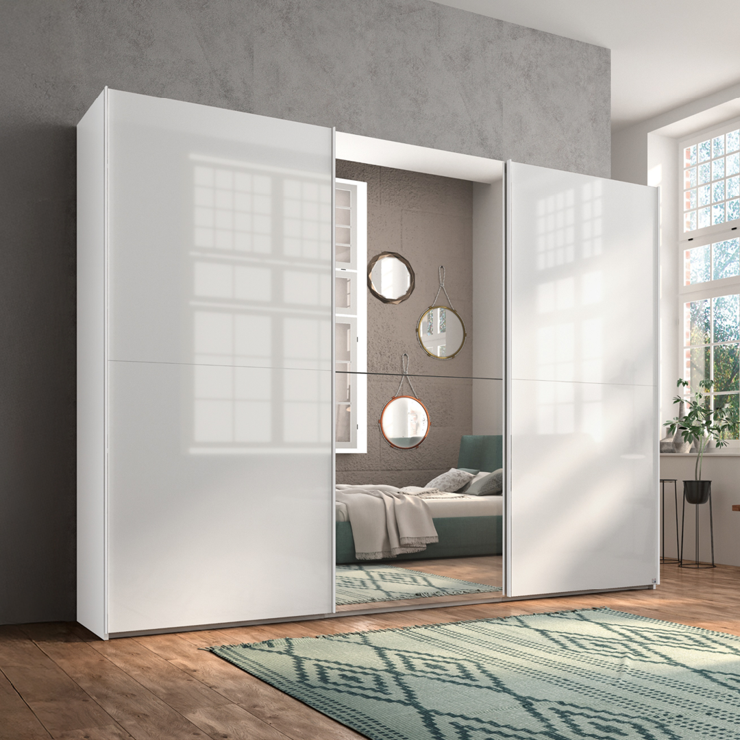 Moderne witte schuifdeurkast met hoogglans afwerking en een geïntegreerde spiegel, geplaatst in een stijlvolle slaapkamer.
