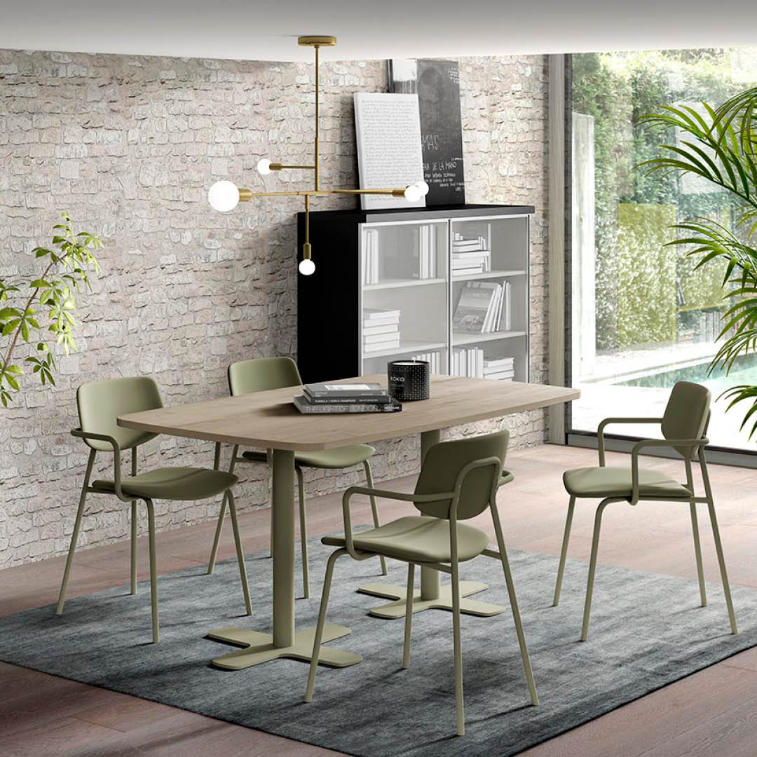 Groene stoelen met armleuningen en buisvormige poten in dezelfde kleur.